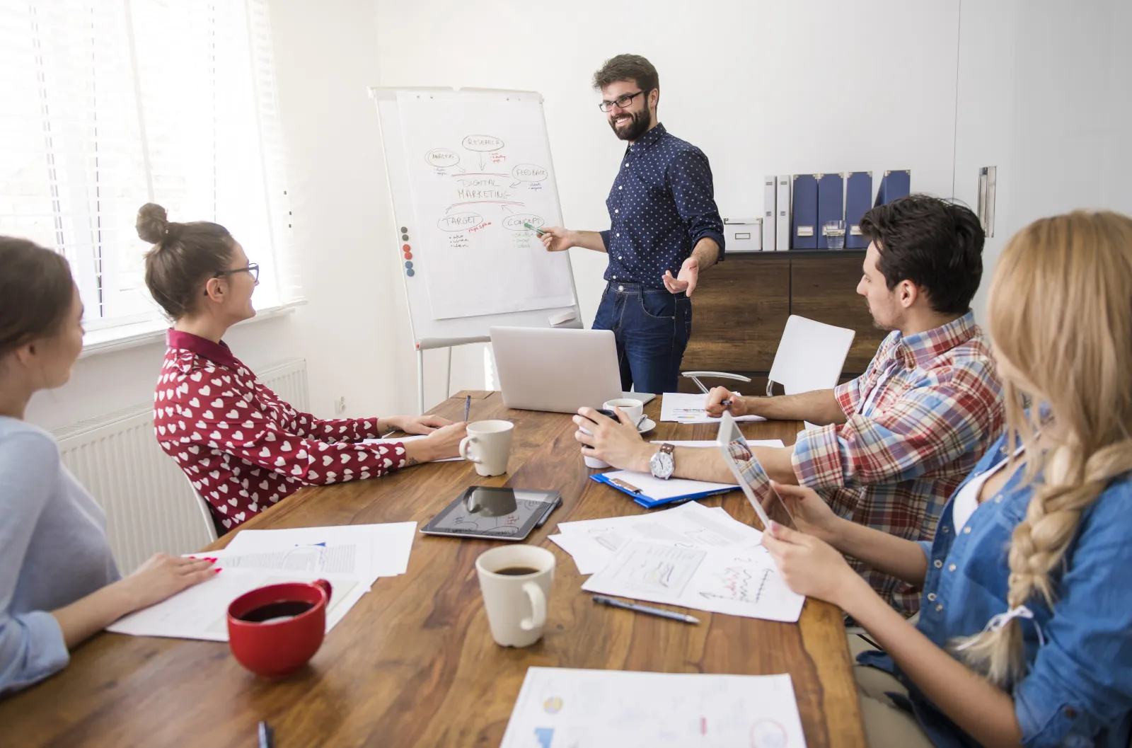 69ca5a056dcbb_executive-presenting-strategy-work1.webp
